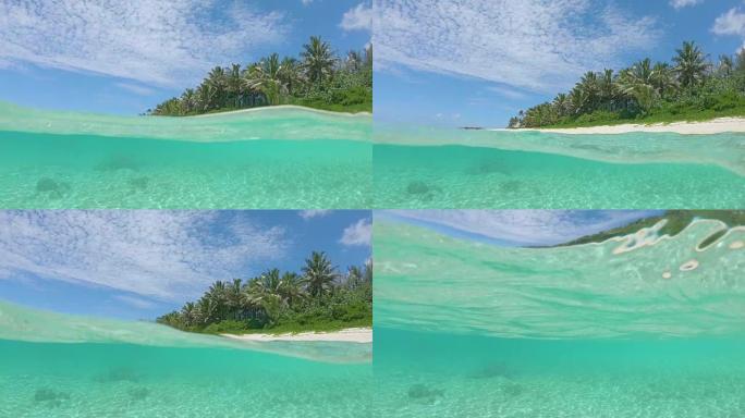 半水下惊人的玻璃状水溅到拍摄热带海岸的相机上