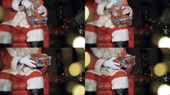 圣诞老人在礼品盒上系丝带。平安夜概念。