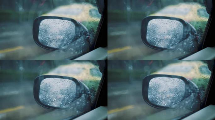 汽车侧镜在雨中，而交通堵塞