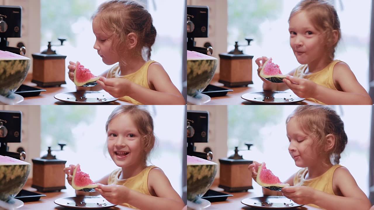 可爱的小女孩在厨房里吃一片西瓜的肖像。女性转身，看着镜头大笑