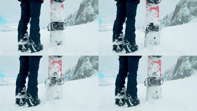 SLO MO滑雪板手在雪地里粘了他的木板