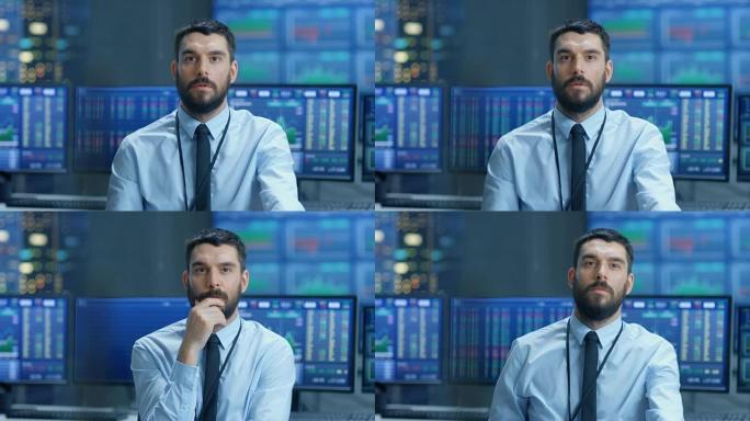 股市顶级交易员努力思考在最佳时机卖出股票。在他身后的工作人员和监控器显示图表和股票代码。