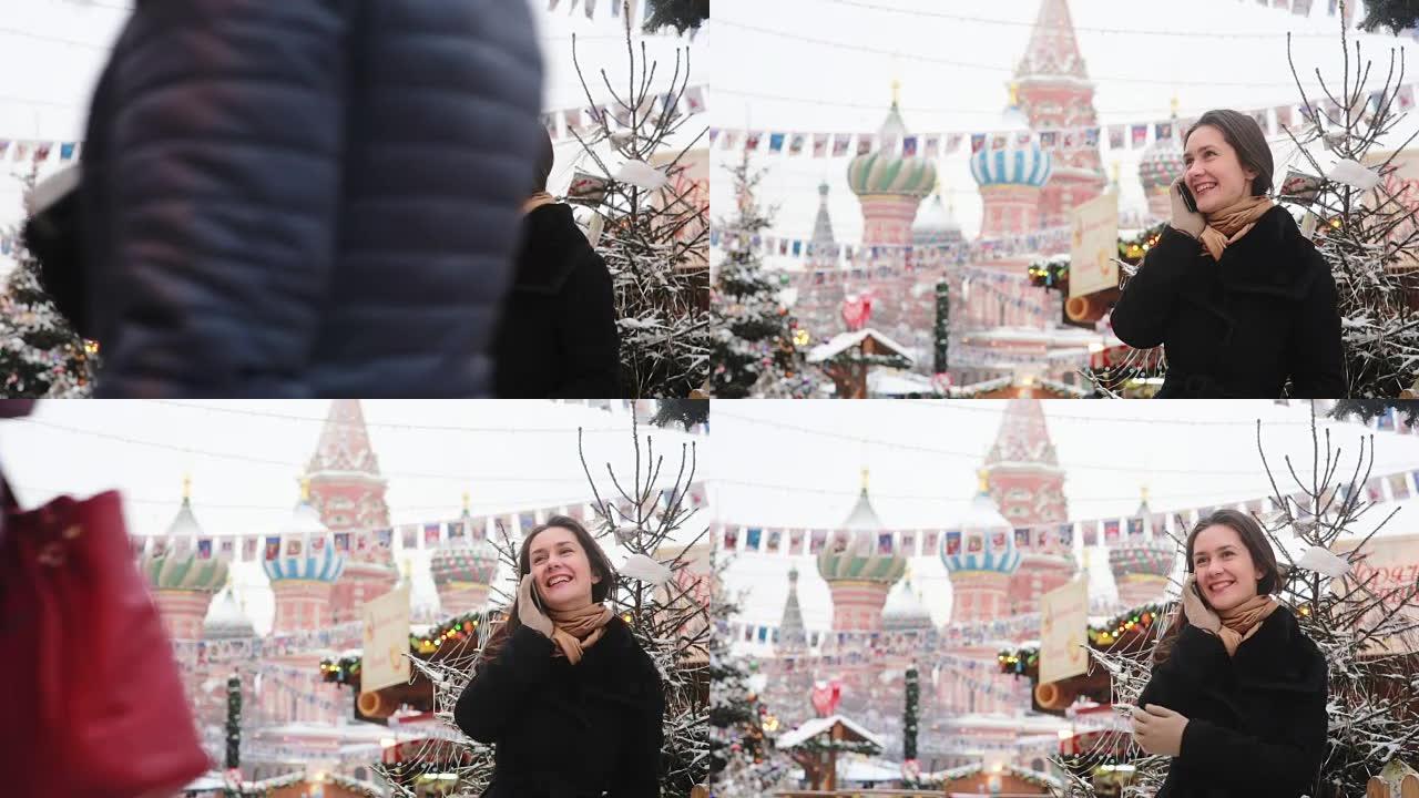 女人在冬天站在莫斯科红场的圣巴西尔大教堂前打电话