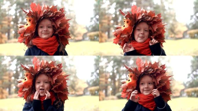 完整高清特写肖像微笑可爱的小女孩在秋天枫叶的花环皇冠摆姿势，做出有趣的面孔