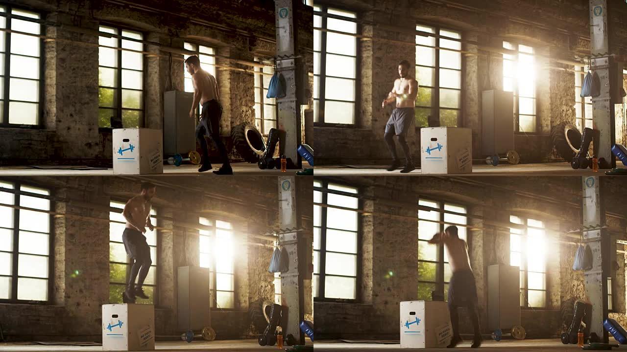 运动赤膊壮汉在硬核健身房做交叉健身训练计划的一部分箱子跳跃。男人因剧烈运动而汗流浃背，健身房位于工业
