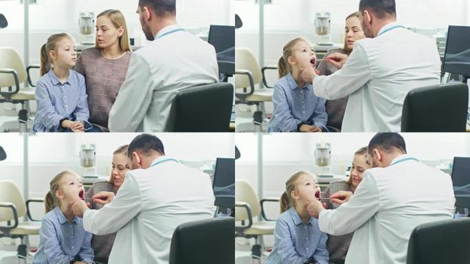 友好的医生检查小女孩的喉咙痛，母亲在场支持。现代医疗保健，友好的儿科医生和明亮的办公室。