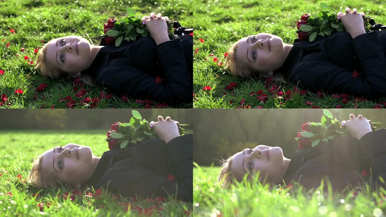 金发女人躺在草地上