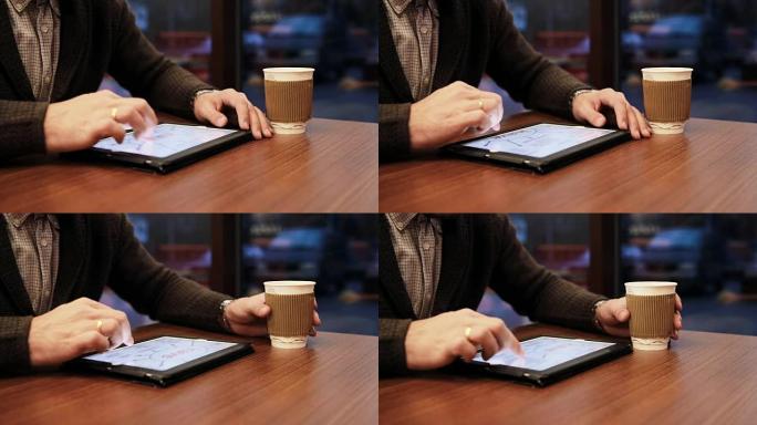 咖啡馆中使用平板电脑触摸屏的人