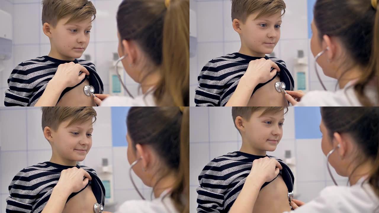 医生用听诊器检查学校男孩。