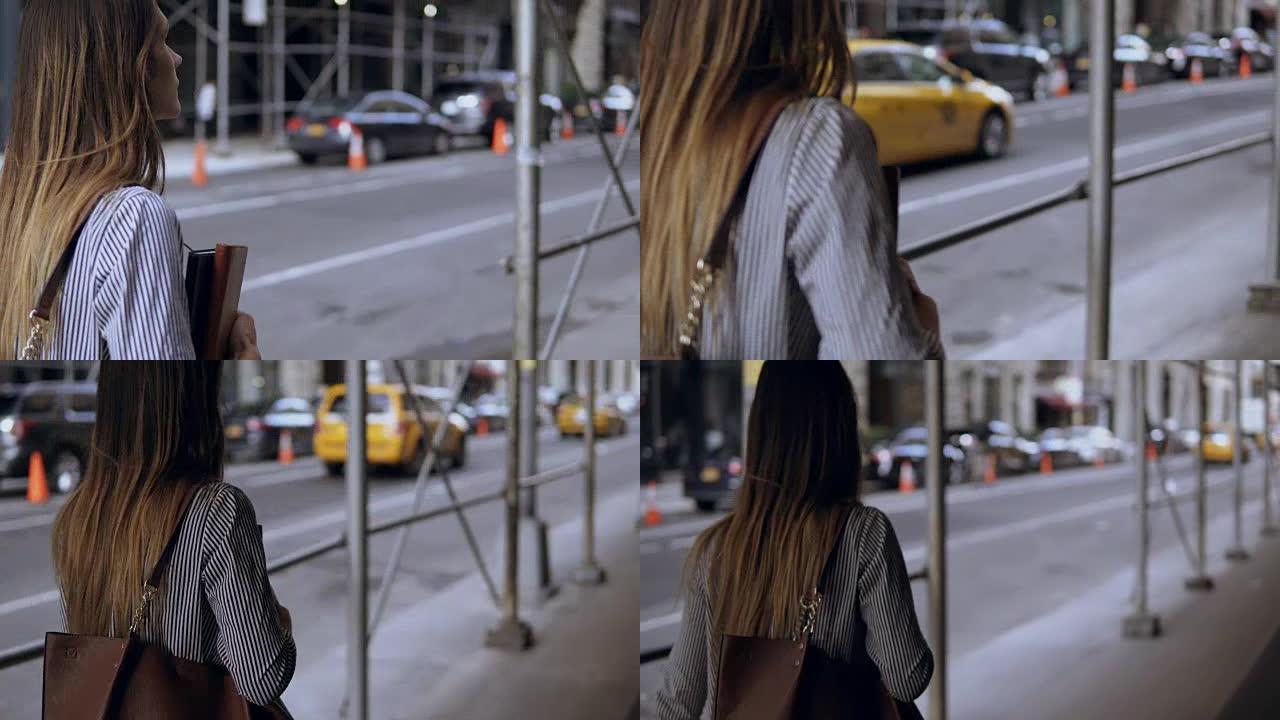 年轻漂亮的女商人走过市中心，靠近美国纽约的建筑