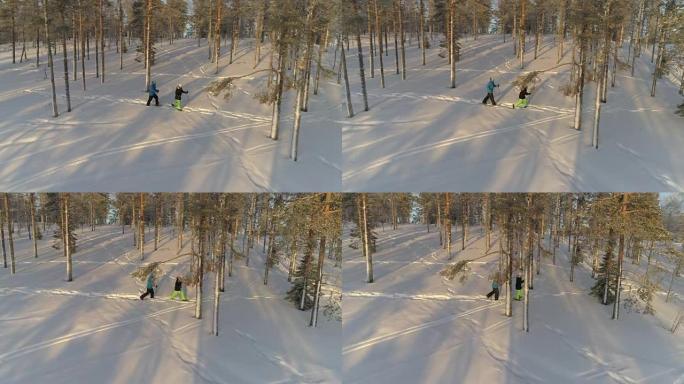 空中: 男人和女人在寒冷的冬天早晨在新鲜的雪上行走