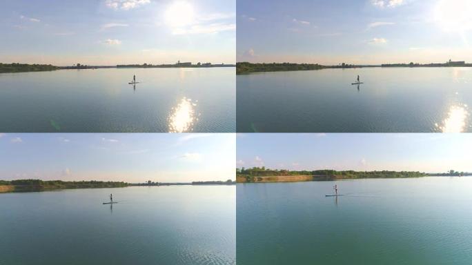 空中女子站立划桨登上湖面