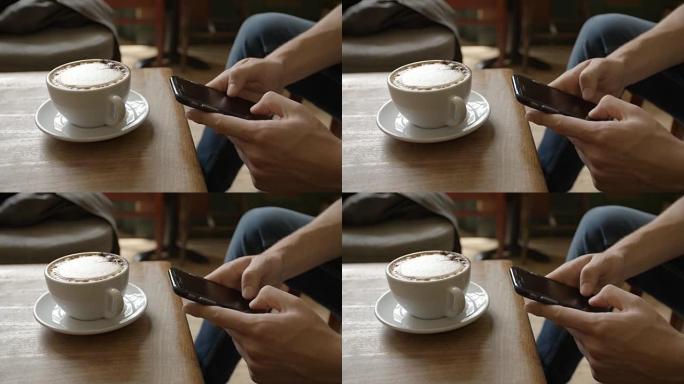 咖啡馆里的年轻人用智能手机传递信息，特写细节