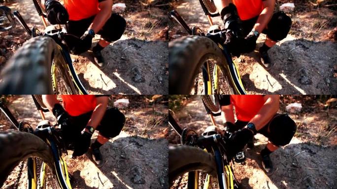 山地车手在小径上修理他的破自行车