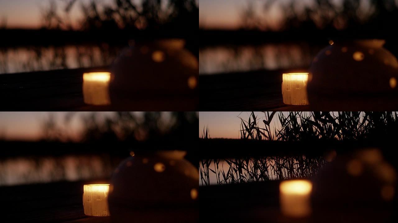 日落时的湖码头。浪漫的蜡烛和灯笼