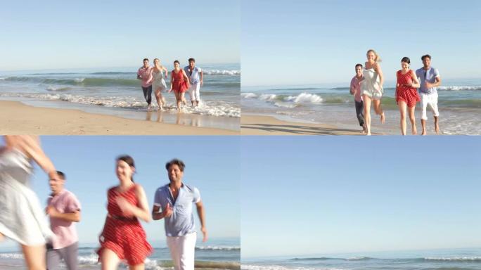 一群朋友在海滩上奔向相机