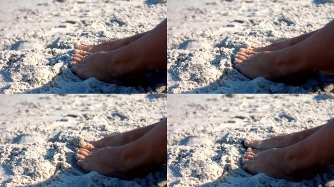女人踩在沙滩上的特写镜头