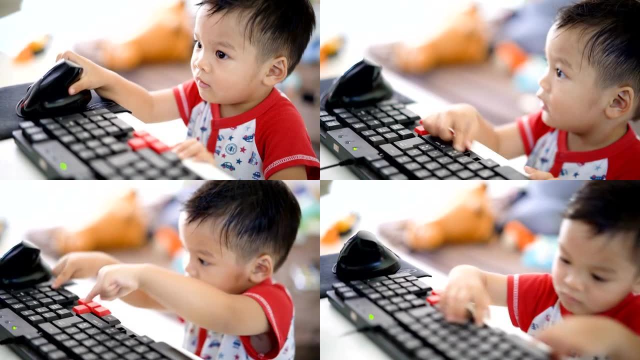 4k亚洲男婴使用台式电脑。