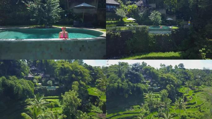 天线: 巴厘岛水稻梯田上方豪华度假胜地无边泳池中的快乐女孩