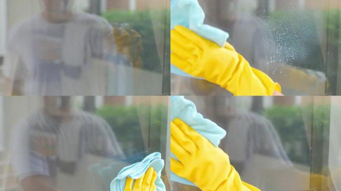 清洁喷涂在窗户玻璃上并用超细纤维布擦拭，清洁镜头概念
