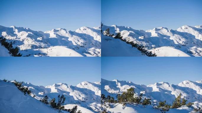 在阳光明媚的冬日，白雪皑皑的山脉的空中拍摄