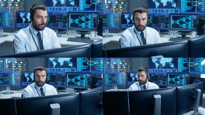 在系统监控室调度员中，戴着耳机的观察员正常运行设施。他被显示技术数据的屏幕包围着。