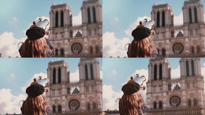 贝雷帽中的女童透过硬币双筒望远镜。慢动作。巴黎圣母院。使用视图望远镜的女学生