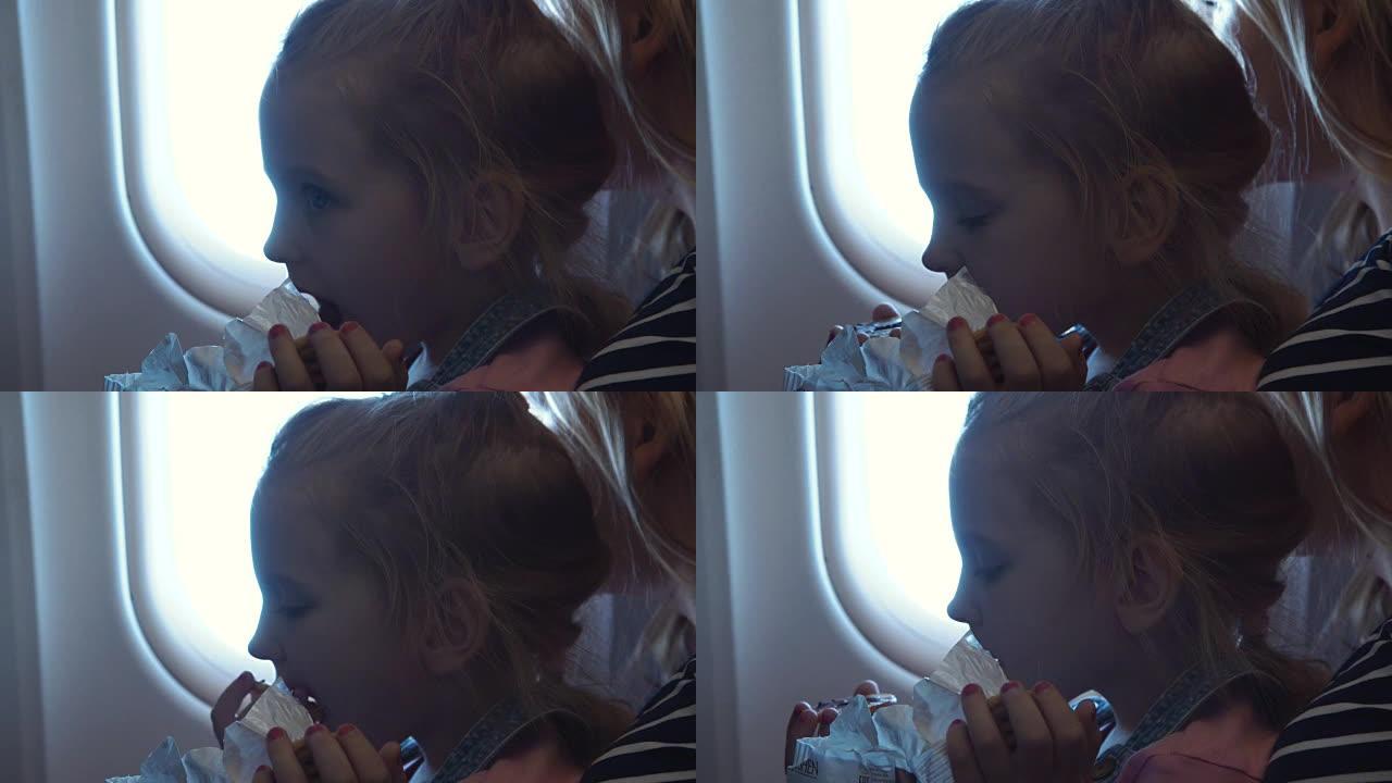 小女孩在飞机上吃饭