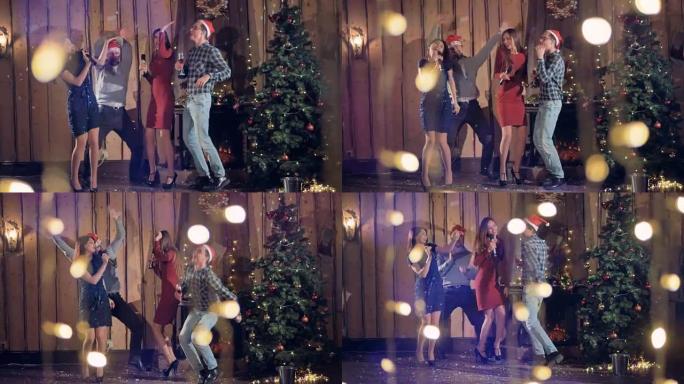 四个朋友在圣诞树旁唱歌跳舞。