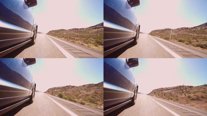 在R3D上拍摄的沿着乡村道路行驶的汽车的低角度视图