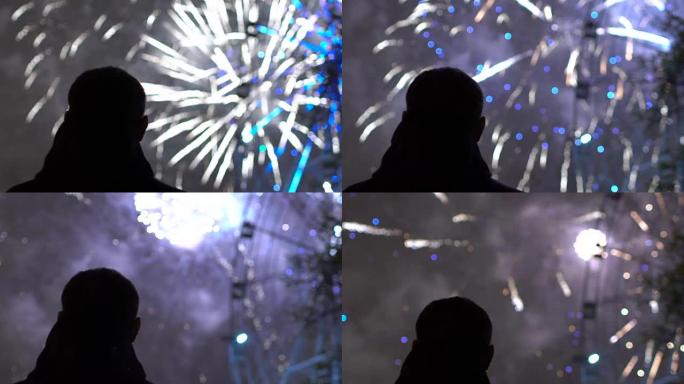户外新年庆祝活动中独自一人观看烟花的特写剪影的慢动作