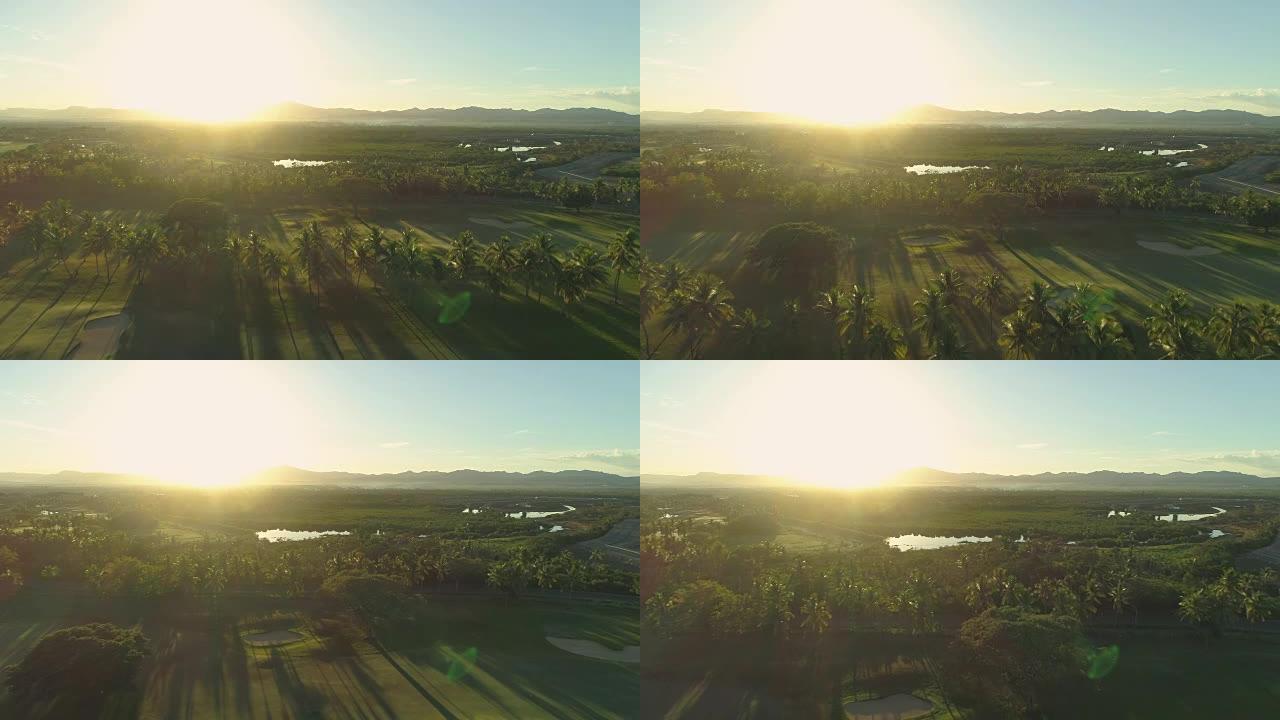 空中，太阳耀斑: 田园诗般的夏日傍晚阳光照耀着豪华高尔夫球场。