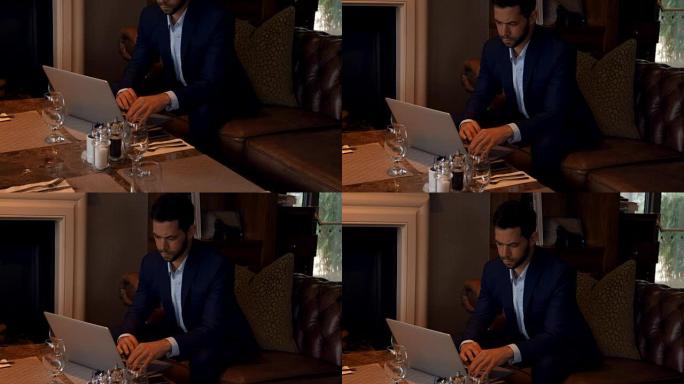 商人在餐桌上使用笔记本电脑4k