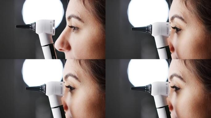 女人用耳镜检查，特写，半边脸