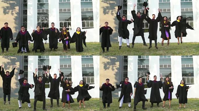 穿着学术服装的成功毕业生拿着文凭，看着相机，微笑着在户外跳跃拍照。