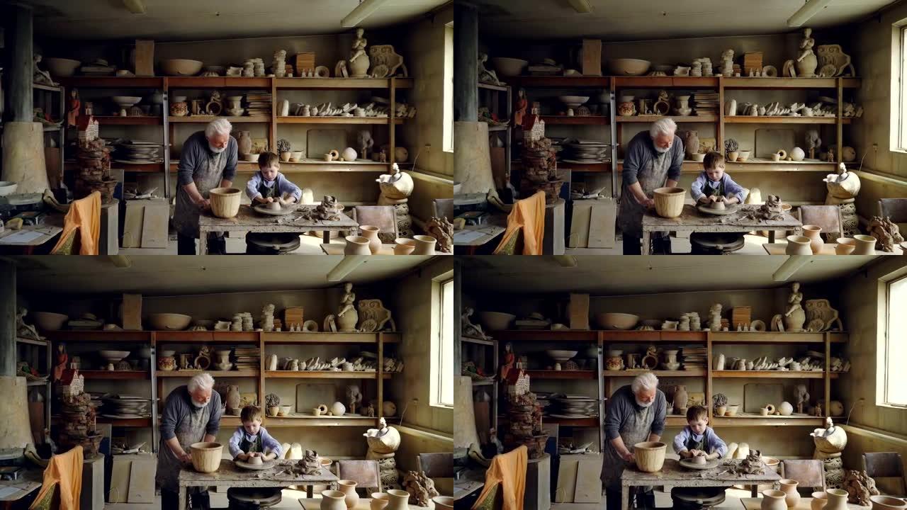 熟练的孩子在他的figuline家庭工作室与祖父一起工作时，正在波特的轮子上形成锅。专业设备和背景精