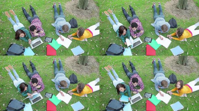 学生一起在草地上学习