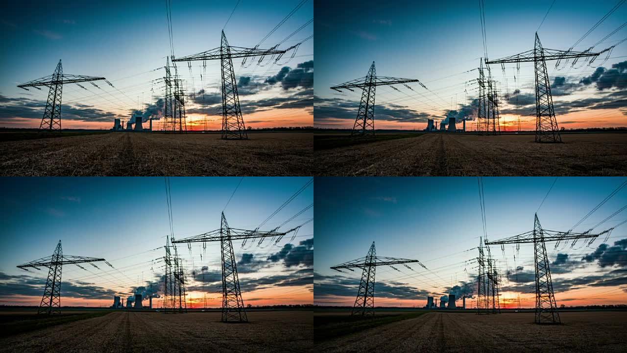 起重机: 日落时田野上的电塔