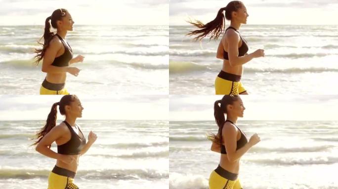 女孩早上在海滩跑步。侧面射击。慢动作。