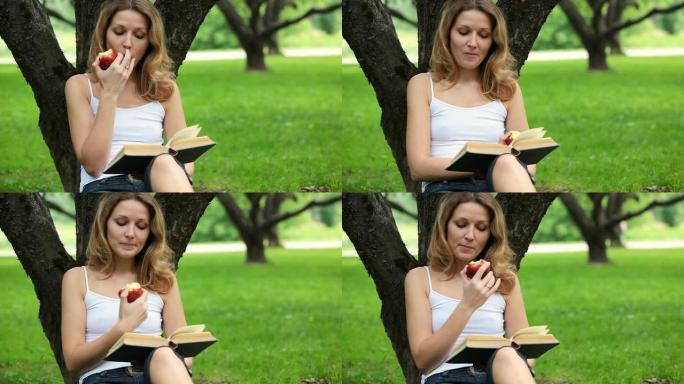 女人在公园看书吃苹果