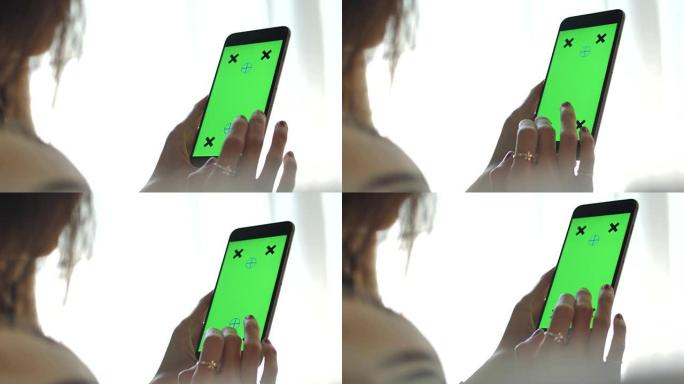 使用智能手机、绿屏手持智能手机的特写