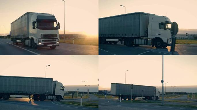 带有货运拖车的半卡车在高速公路上行驶的后续镜头。白色卡车在清晨驶过工业仓库区。