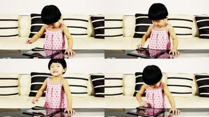 一个小女孩在玩一个小女孩在玩平板电脑