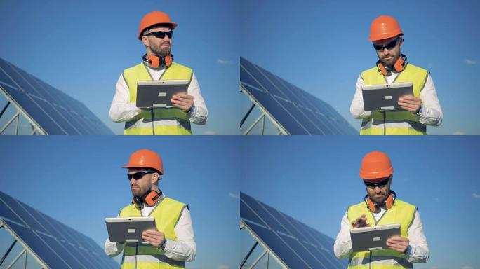 一名男性检查员站在太阳能电池板附近的计算机上的工作过程