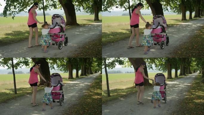 慢动作: 与妈妈一起散步时，推着婴儿车的小女孩向后看。