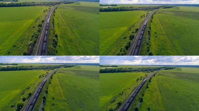 火车上有货车穿过绿色的夏季田野。4K。