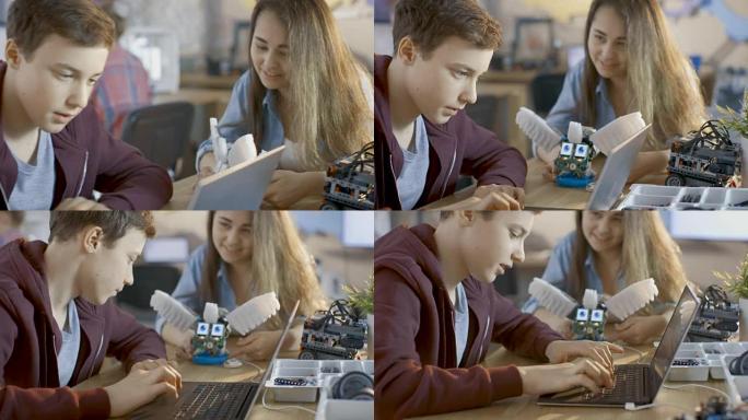 女孩和男孩在学校为他们的科学/机器人/工程课程提供功能齐全的机器人和笔记本电脑。