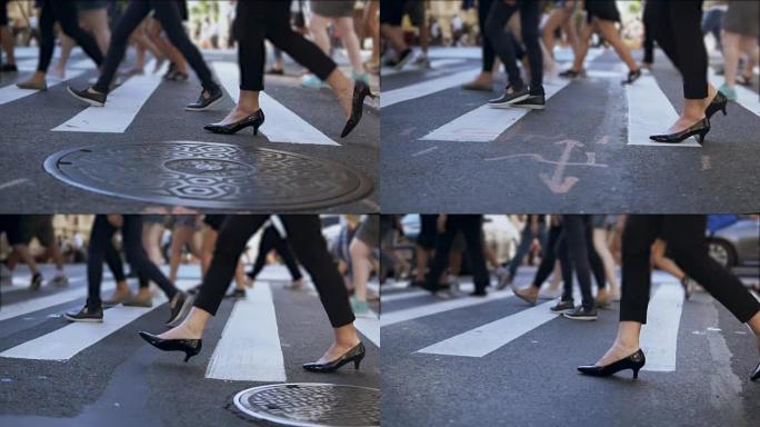 时尚女性脚的特写视图。在拥挤的市中心过马路的女商人。慢动作