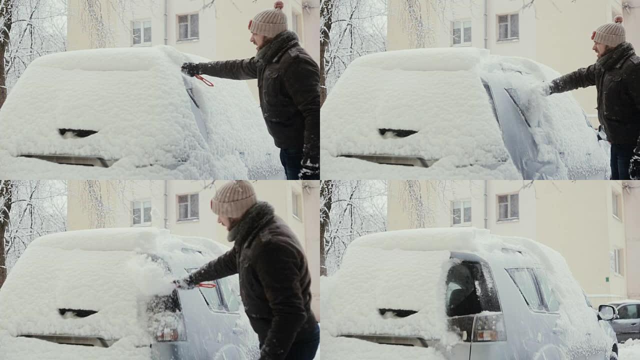 冬天，男子在街上清除汽车上的积雪，后视图