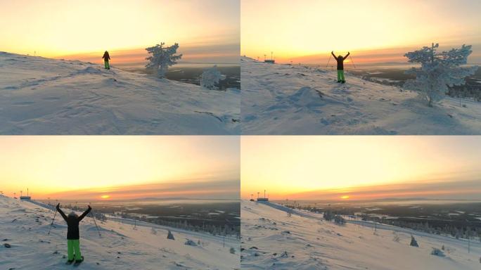 空中活跃的女人雪鞋在雪山斜坡上抬起手臂